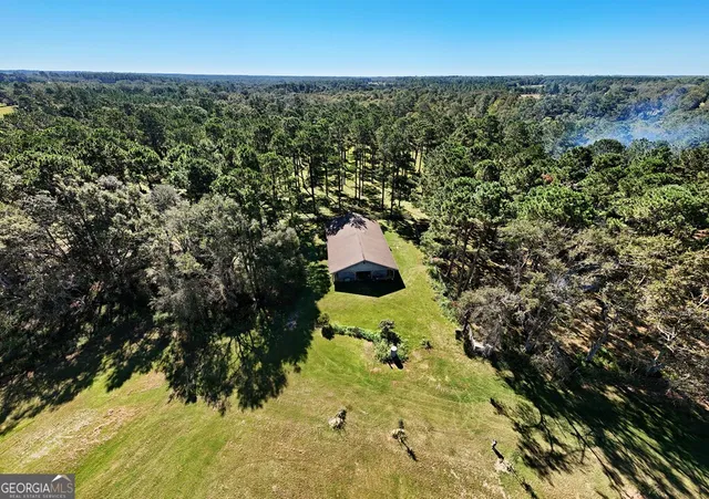 an aerial view of residential house with yard and outdoor space