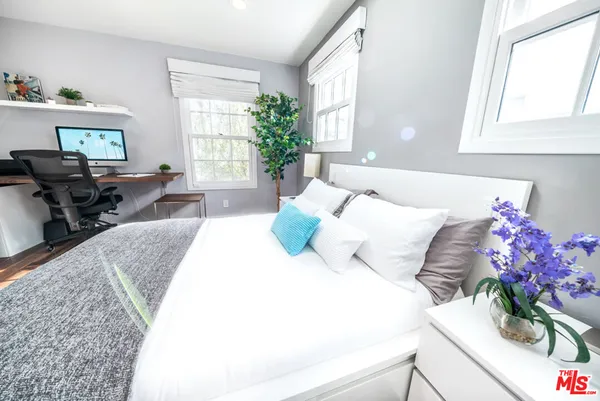 a bedroom with bed and window