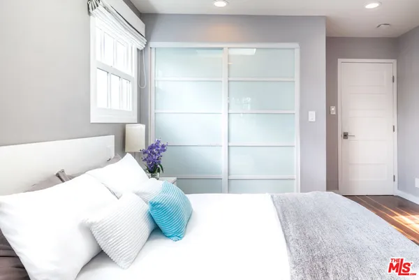 a bedroom with a bed and a window