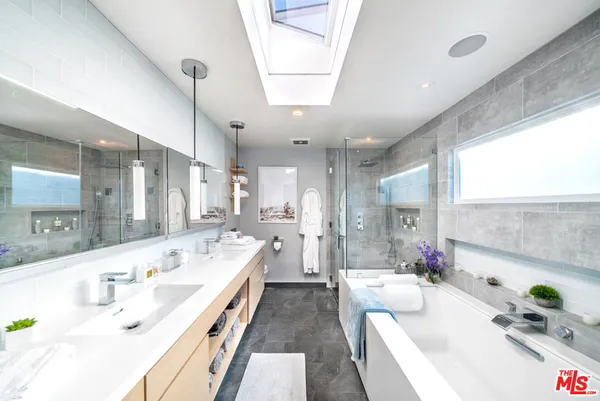 a large white kitchen with a large window