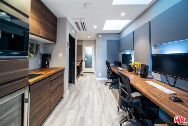 a kitchen with stainless steel appliances kitchen island granite countertop a large stove a sink and a refrigerator