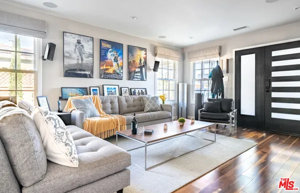 a living room with furniture and large windows