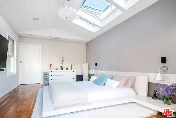 a large white bed in a white room