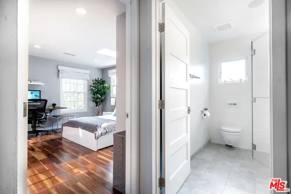 a spacious bedroom with a bed and a couch