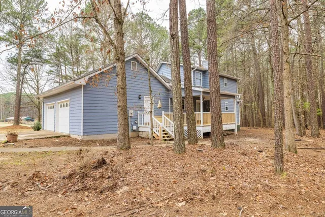 a view of a house with a yard covered in snow