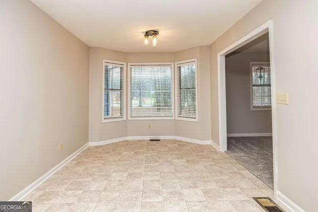 an empty room with windows and closet