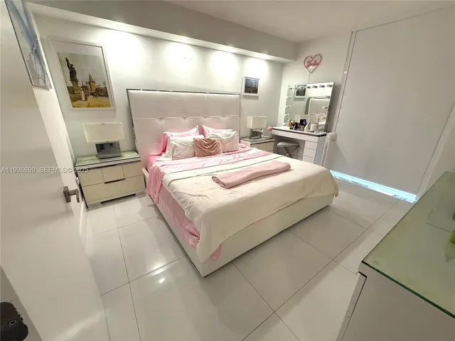 a bedroom with a bed and a mirror