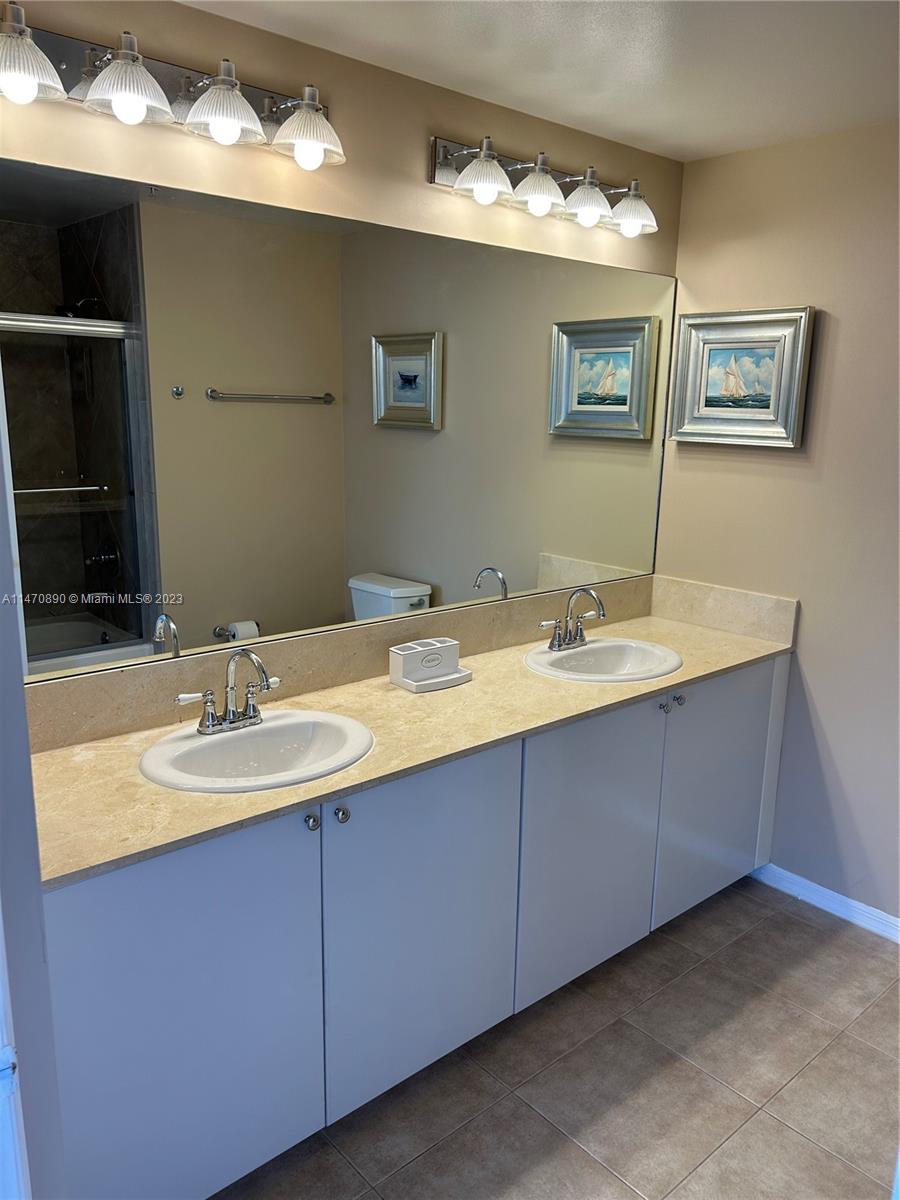 233 South Federal Highway, Unit 609 Boca Raton, FL 33432 - Photo 11 of 24 a bathroom with a double vanity sink and a mirror