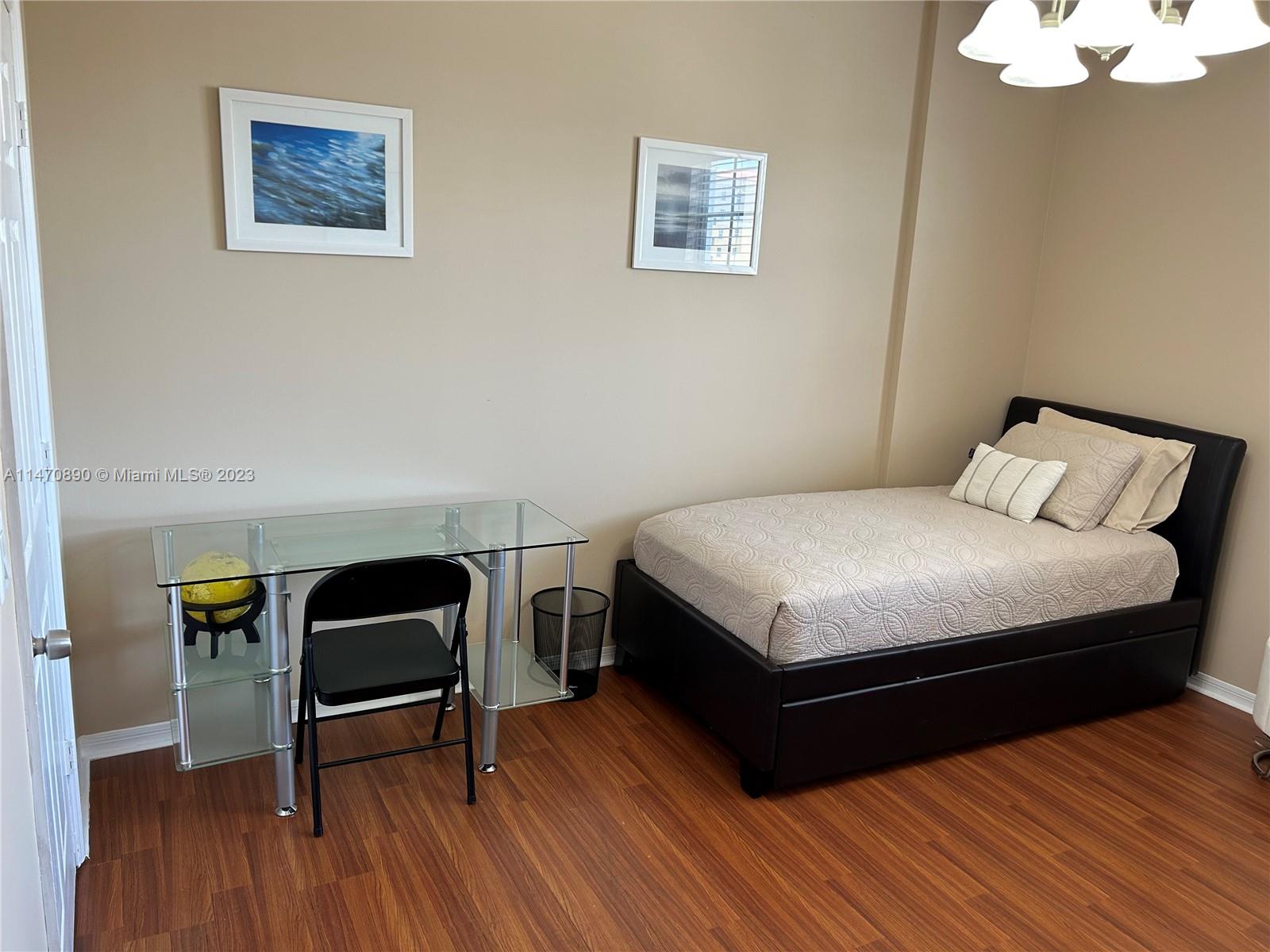 233 South Federal Highway, Unit 609 Boca Raton, FL 33432 - Photo 14 of 24 a bedroom with a bed a table and chair