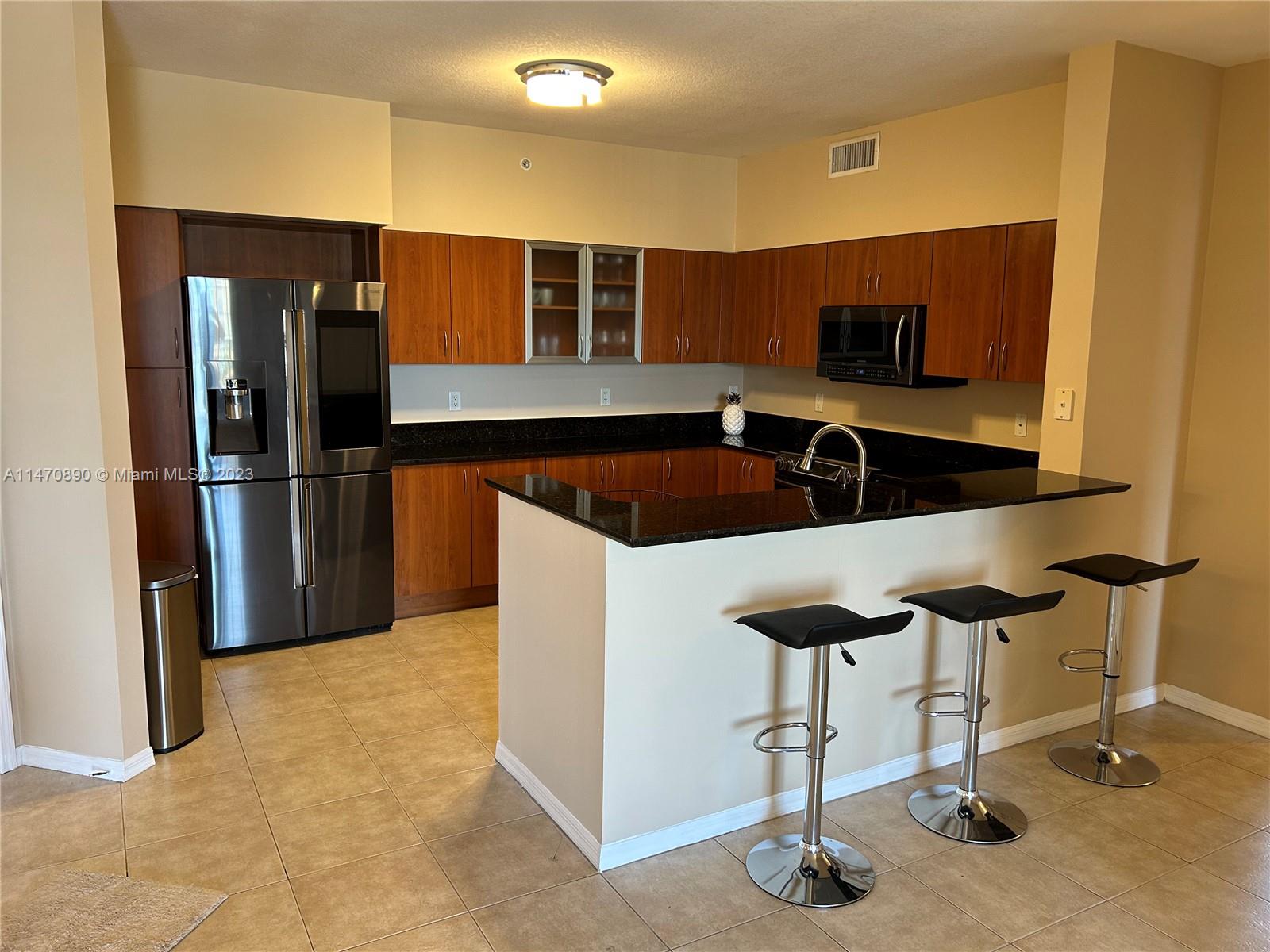 233 South Federal Highway, Unit 609 Boca Raton, FL 33432 - Photo 5 of 24 a kitchen with stainless steel appliances granite countertop a refrigerator and a stove top oven