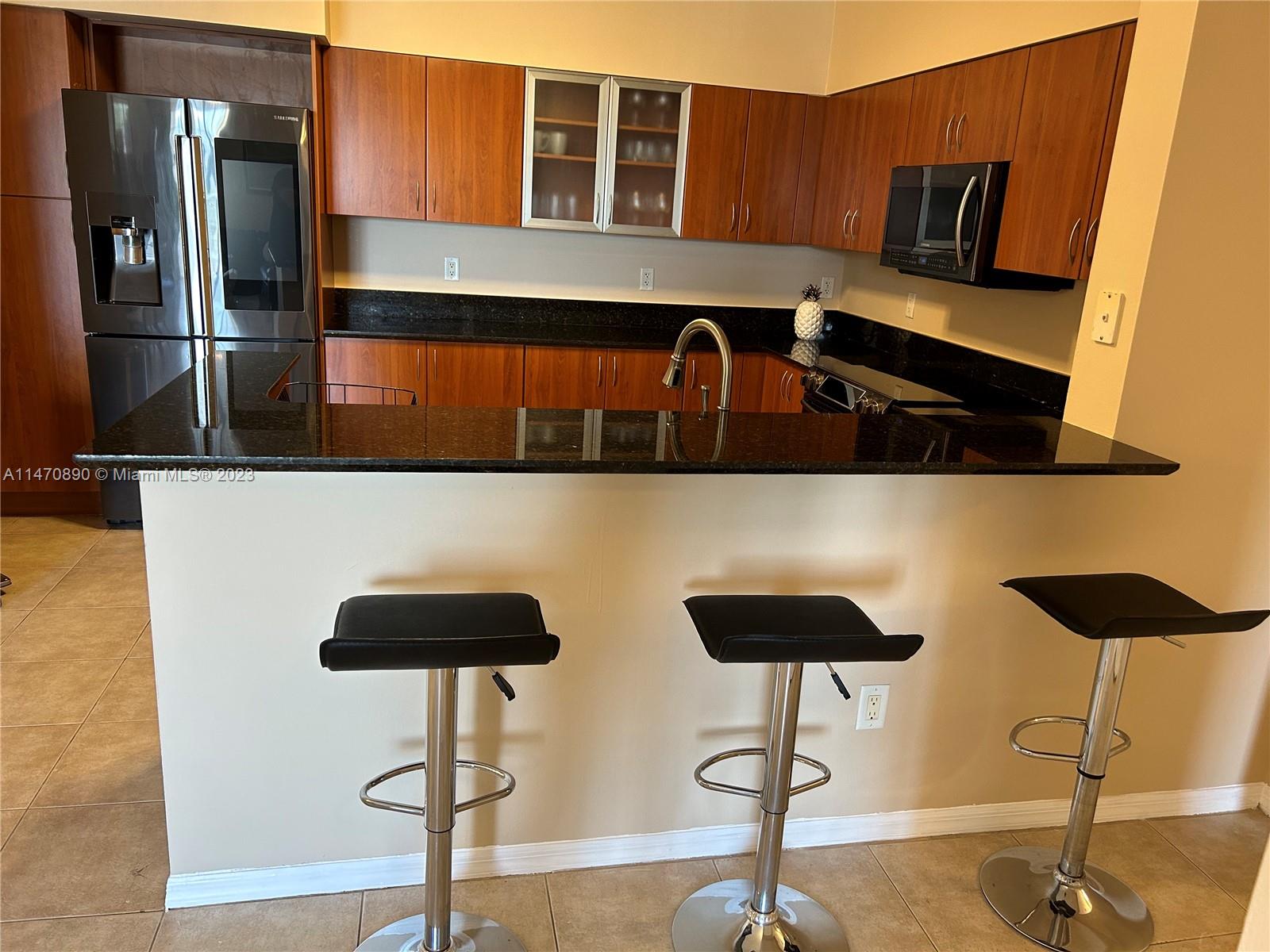 233 South Federal Highway, Unit 609 Boca Raton, FL 33432 - Photo 8 of 24 a kitchen view with chairs in front of the wall