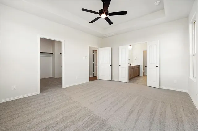 a view of empty room with ceiling fan