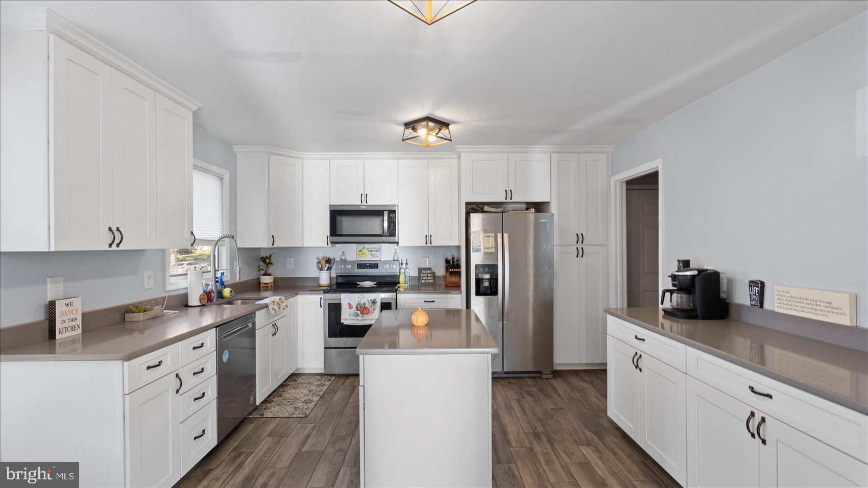 9905 Magledt Road Baltimore, MD 21234 - Photo 12 of 45 a kitchen with stainless steel appliances a refrigerator sink and white cabinets