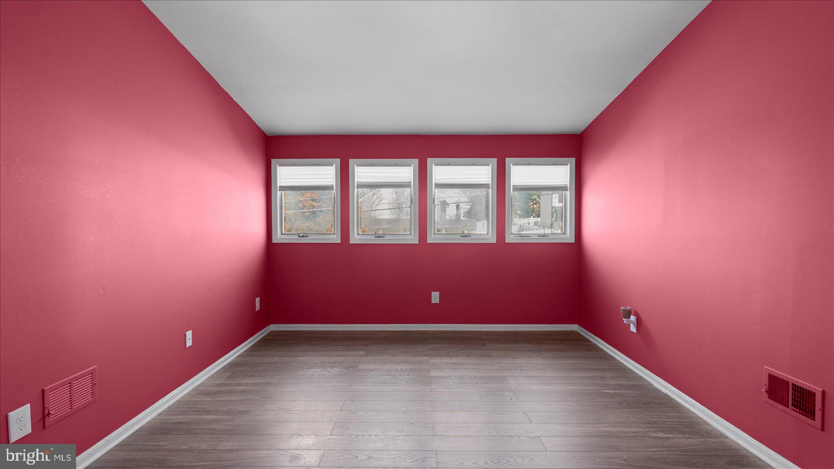 9905 Magledt Road Baltimore, MD 21234 - Photo 24 of 45 an empty room with wooden floor and windows