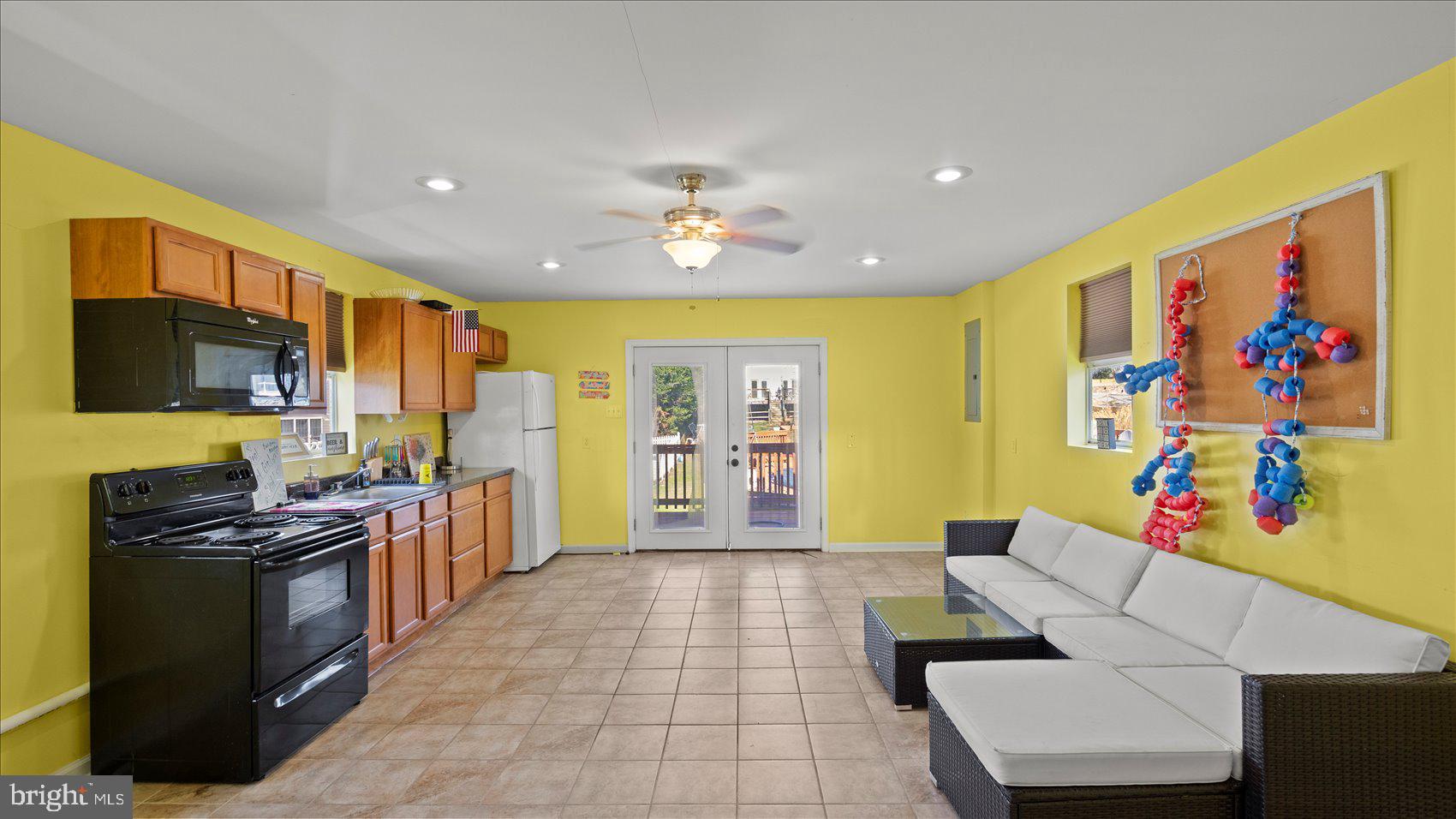 9905 Magledt Road Baltimore, MD 21234 - Photo 35 of 45 a living room with stainless steel appliances furniture and a flat screen tv