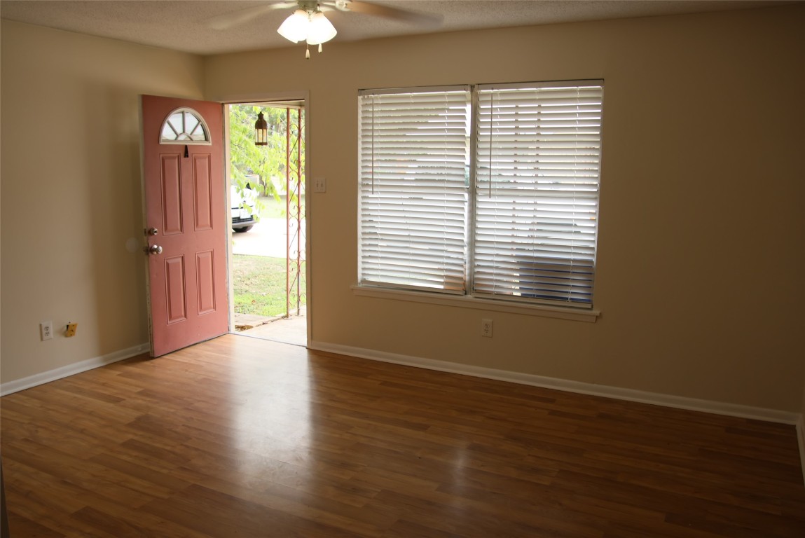 2713 St Edwards Circle, Unit A Austin, TX 78704 - Photo 2 of 11 Foyer with wood laminate floors, ceiling fan, and a textured ceiling