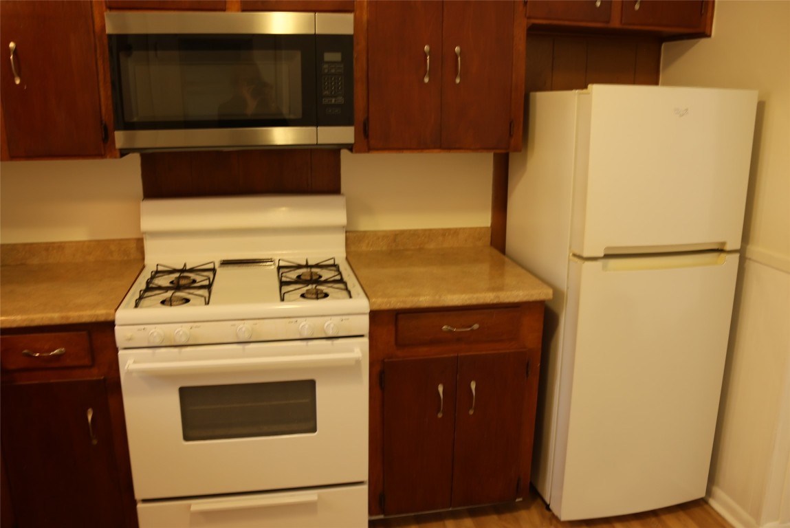 2713 St Edwards Circle, Unit A Austin, TX 78704 - Photo 9 of 11 Kitchen with white appliances, light countertops, and light wood-style floors