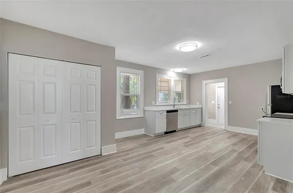 a view of a kitchen with a sink and a large window