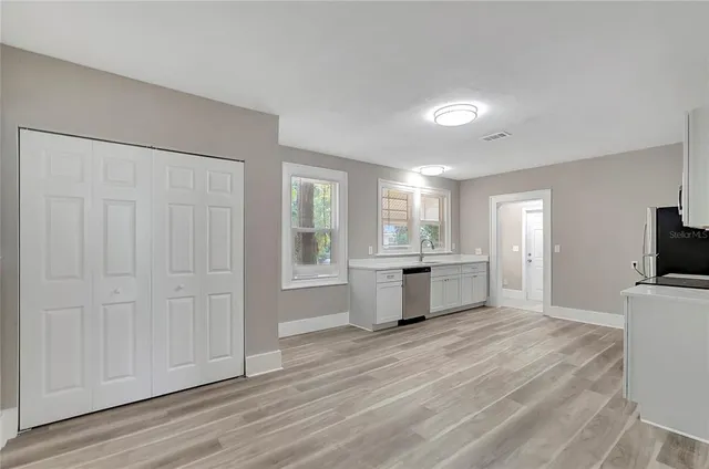 a view of a kitchen with a sink and a large window