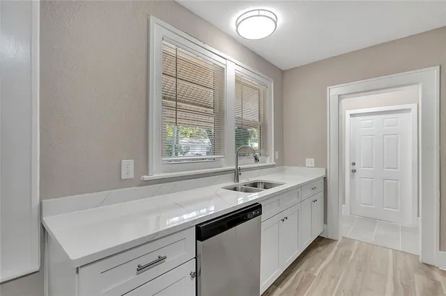 a spacious bathroom with a sink and a window