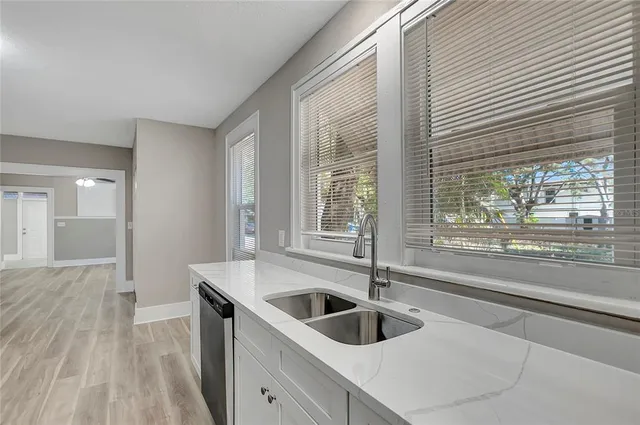 a kitchen with a sink and large window