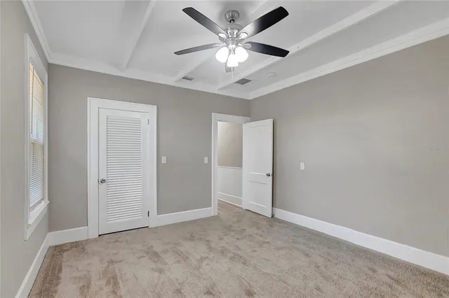 a view of an empty room with a ceiling fan