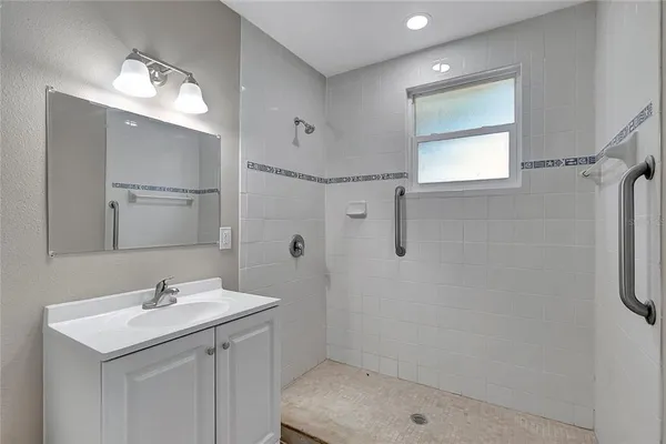 a bathroom with a sink a light fixture and a mirror