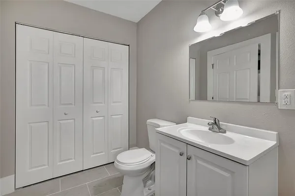 a bathroom with a sink a toilet and a mirror