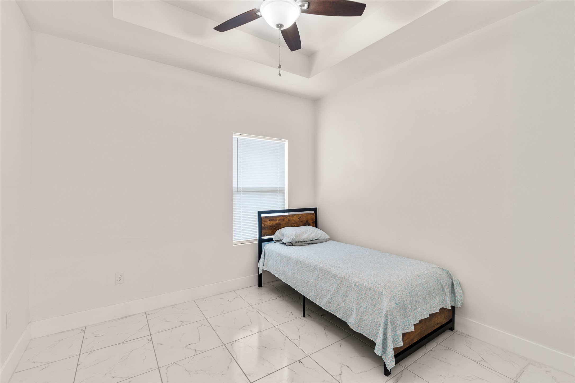 23232 Val Verde Edcouch, TX 78538 - Photo 7 of 19 a bedroom with a bed and a chandelier fan