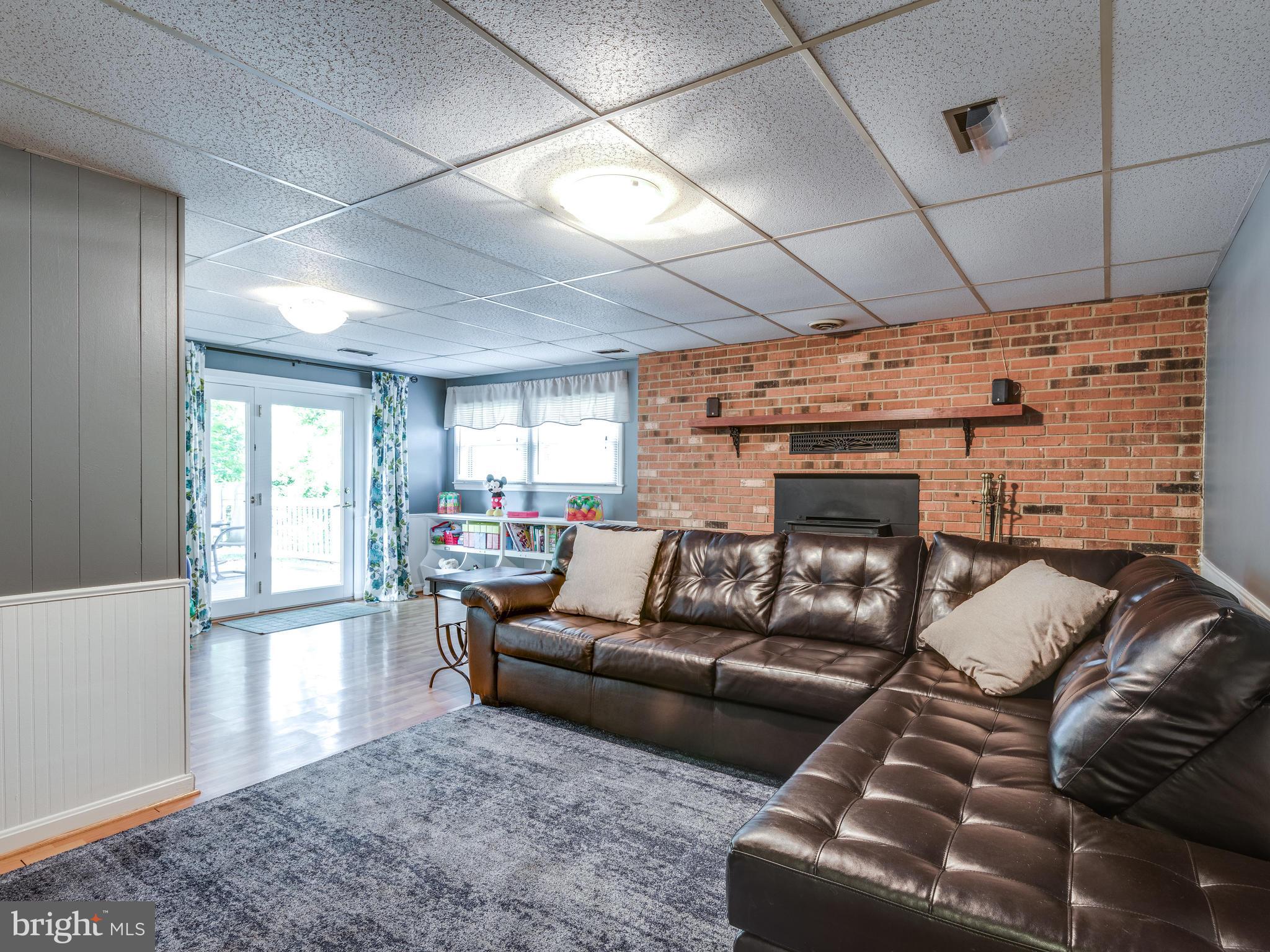 801 West Poplar Road Sterling, VA 20164 - Photo 19 of 30 Basement Rec Room W/ Wood Burning Stove