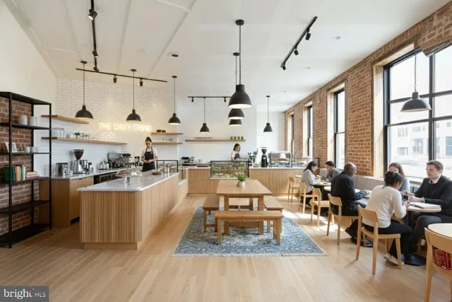 a bedroom with furniture and a large window