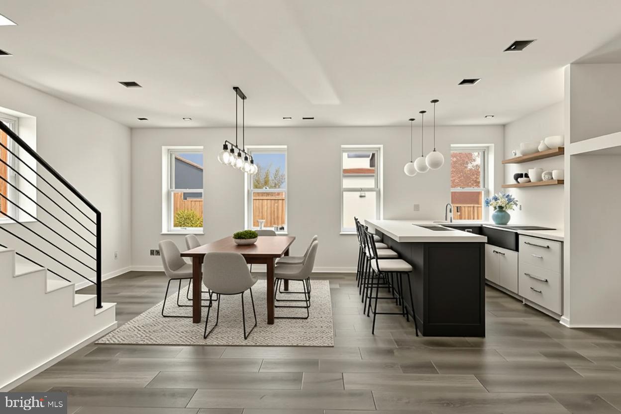 2324 North Capitol Street Northwest Washington, DC 20002 - Photo 18 of 35 a dining room with wooden floor a chandelier a wooden table and chairs