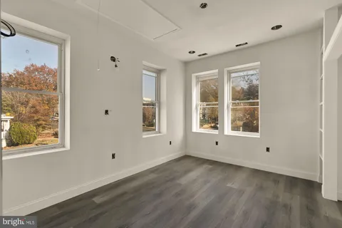 a bedroom with bed and glass window
