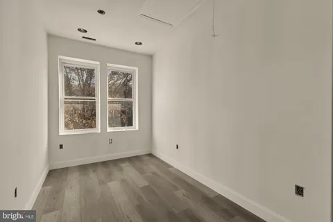 a bathroom with a sink a large mirror and a bathtub
