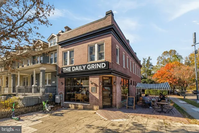 a front view of a building with sitting area