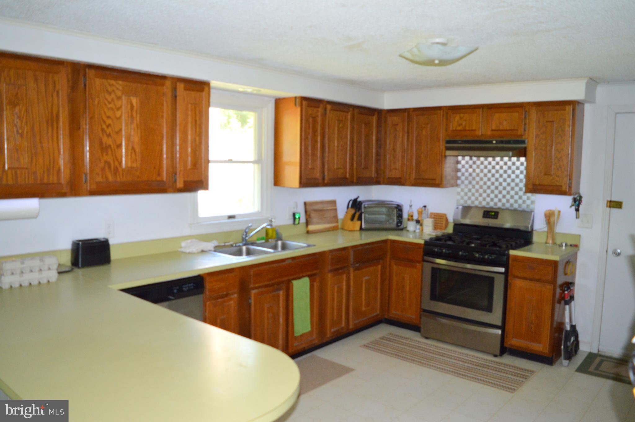 4666 Maiden Forest Road Rhodesdale, MD 21659 - Photo 8 of 17 a kitchen with stainless steel appliances granite countertop a sink stove and refrigerator