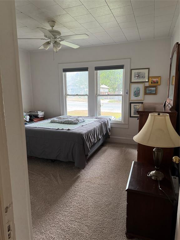 2300 Lyle Avenue Waco, TX 76708 - Photo 14 of 23 Bedroom featuring dark colored carpet and a ceiling fan