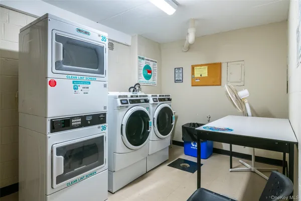 a utility room with dryer washer and a view of kitchen