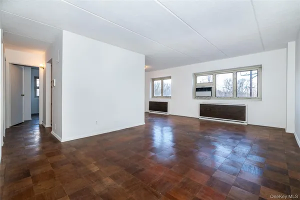 an empty room with windows and entrance