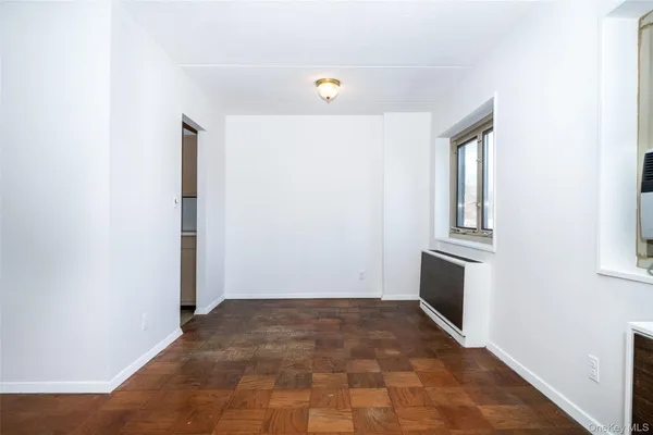 a view of a kitchen with wooden floor and electronic appliances
