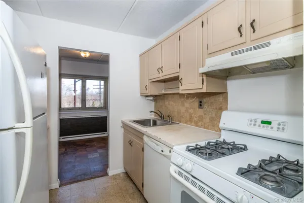 a kitchen with a stove and a refrigerator