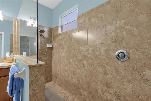 a bathroom with a shower and a sink