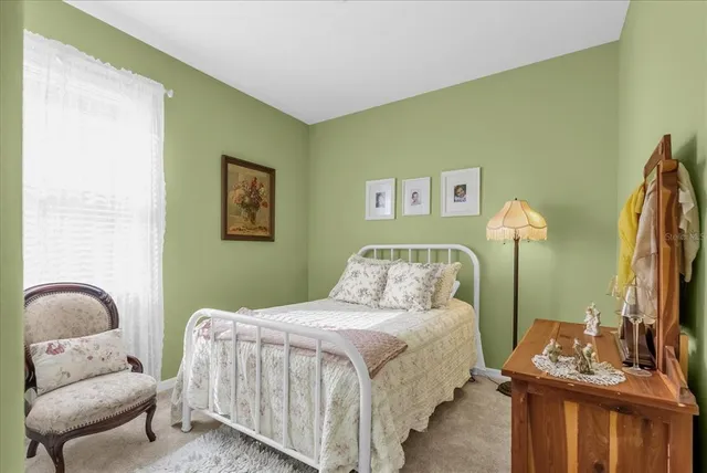 a bedroom with bed and a couch