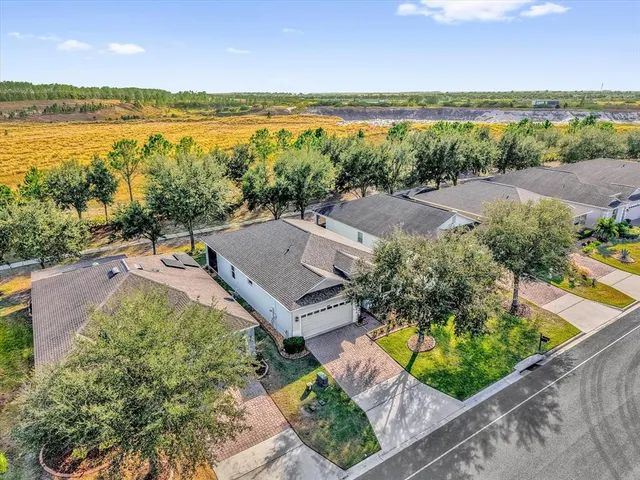 an aerial view of ocean with residential house and outdoor space