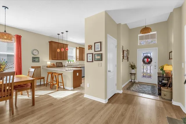 a living room with stainless steel appliances kitchen island granite countertop furniture and a wooden floor