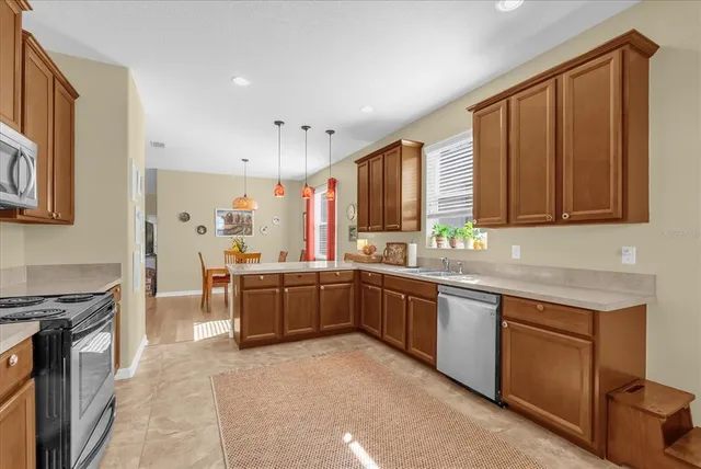 a kitchen with stainless steel appliances granite countertop a stove sink and cabinets