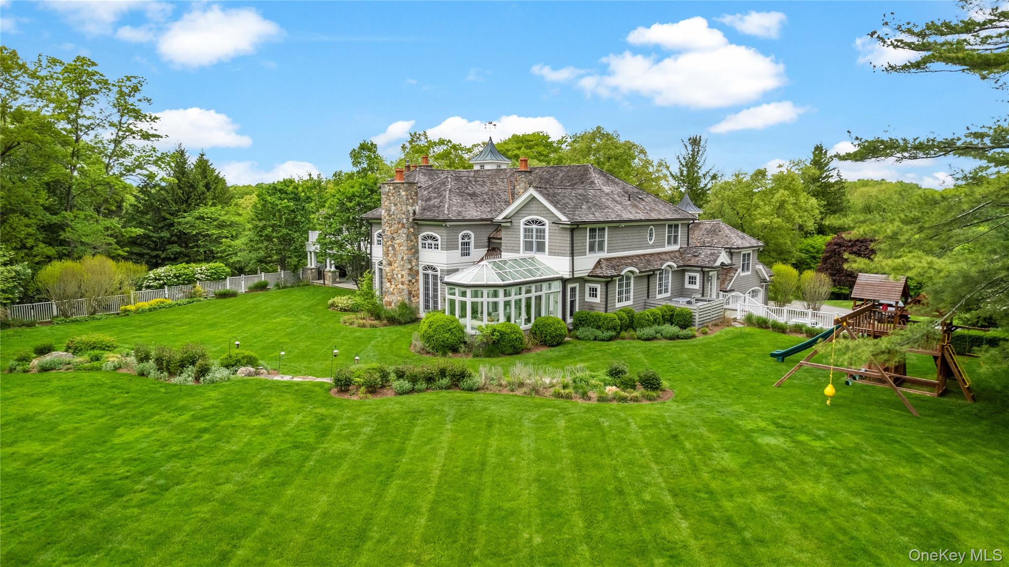 63 Old Mill River Road Pound Ridge, NY 10576 - Photo 41 of 47 a front view of a house with a garden