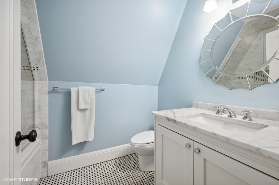 626 Warwick Road Kenilworth, IL 60043 - Photo 32 of 56 a bathroom with a granite countertop sink a toilet and a mirror