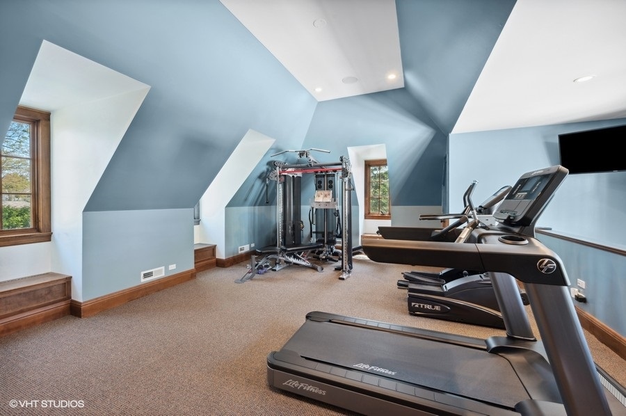 626 Warwick Road Kenilworth, IL 60043 - Photo 36 of 56 a room with gym equipment and large mirror