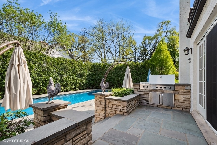 626 Warwick Road Kenilworth, IL 60043 - Photo 41 of 56 a view of a backyard with plants and outdoor seating